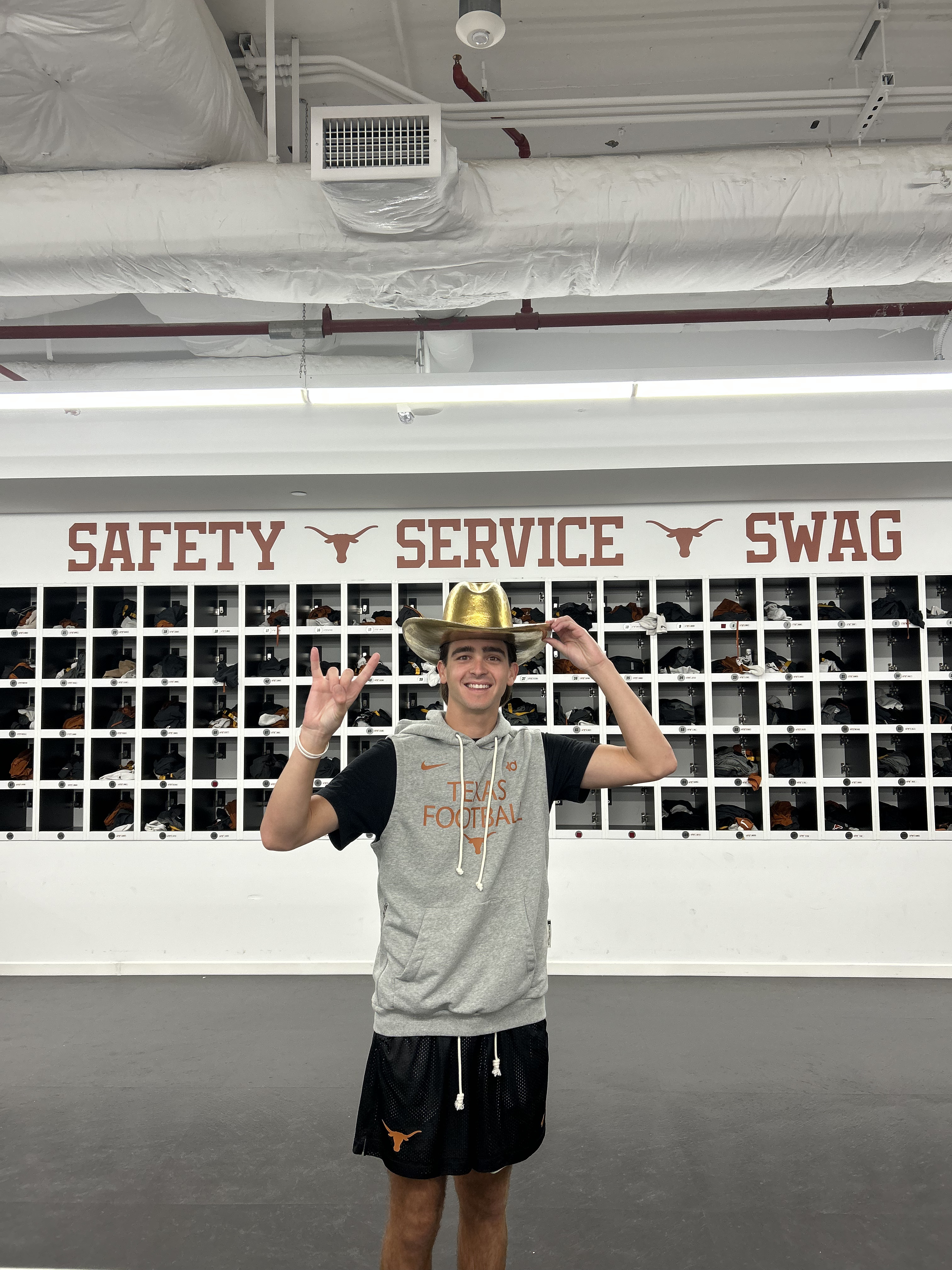 Cooper Webber with the Golden Cowboy Hat after Texas beats OU